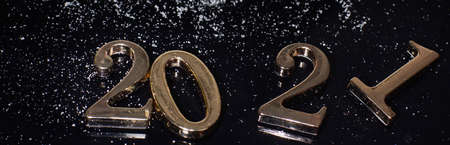Metal numbers 2021 on a dark background, an elongated panoramaの写真素材