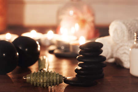 green jade roller for facial massage on a table with spa accessories.の写真素材