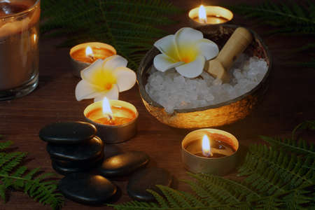 Stones for hot massage stand in a pyramid on the background of a spa composition.の写真素材
