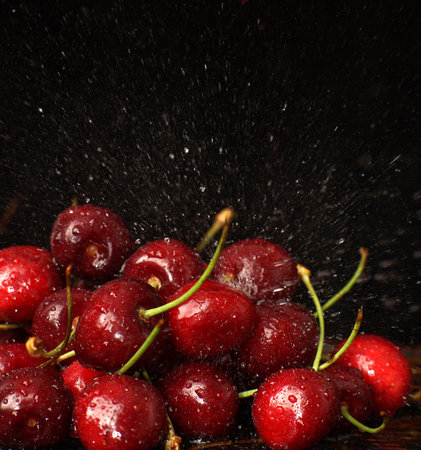 Sweet cherry with water droplets on a dark background.の写真素材