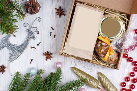Deer and beads christmas gift in a layout with fir branches on a light backgroundの写真素材