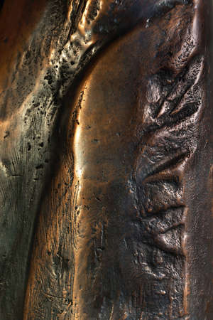 Background from a large piece of bronze with beautiful tints of color.の写真素材