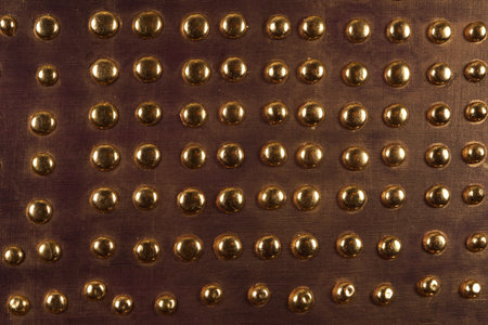 Brown wood background with metal gold buttons, high resolution.の写真素材