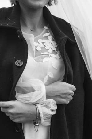 The bride wrapped herself in her husband's coatの写真素材