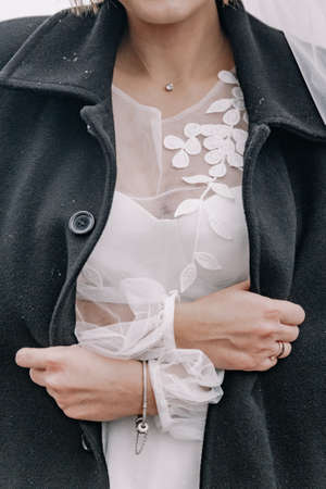The bride wrapped herself in her husband's coatの写真素材
