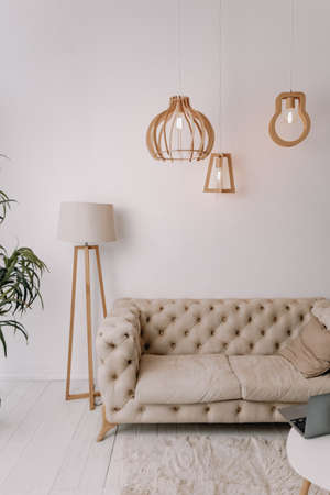 Bright lounge with sofa and lampsの写真素材