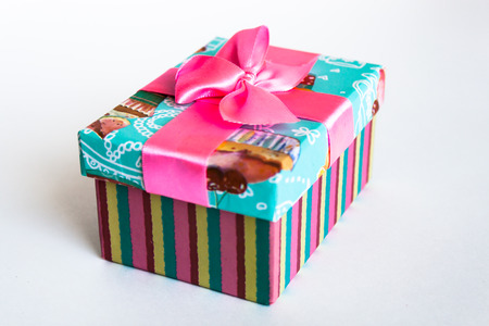 Colored gift box with a bow on a white backgroundの写真素材