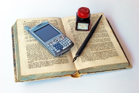 Smartphone, cell phone, over a old book with ink and pen. A smartphone is a mobile phone offering advanced capabilities beyond a typical mobile phone, often with PC-like functionalityの写真素材