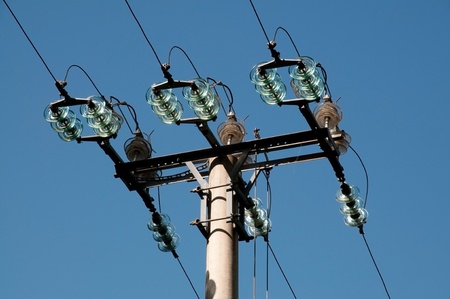 Electrical pole with insulators located between the mountains (Dolomites, Italy)の写真素材