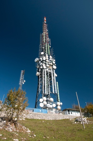 Big television and radio tower with several parabolic antenna on high quote (mountain) - Roncola (Italy)の写真素材