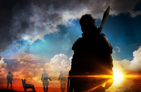 Silhouette of soldier at sunsetの写真素材