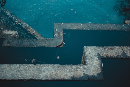 Standing water in the disabled waterfall. Old geometric architectureの写真素材