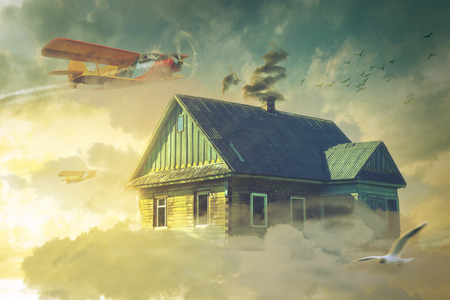The house in the clouds hovering above the groundの写真素材