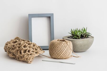 Jute ball, cutter and photo frame on white