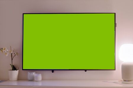 The TV is on the table, the green background on the TV.の写真素材
