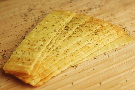 Spiced Homemade Long Potato Chips. Potato from the oven only, rosy, chips with cheese, bacon. Long Chips. Chips on a wooden wall.の写真素材