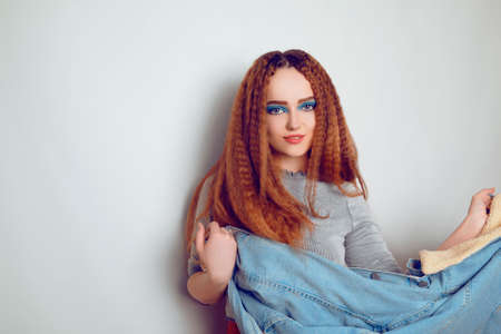 A girl with curled voluminous hair is dancing, a model in the style of the 80s. 90s, with bright...