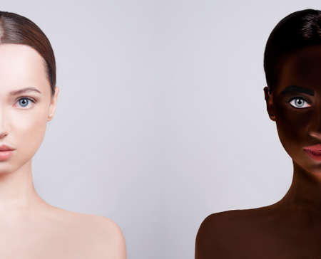 No to racism, the concept of sameness. Faces of two girls nearby, Caucasian-looking girl and African American. Beauty photo of girls of different nationalities, beauty.の写真素材