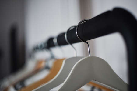 Empty hangers in the dressing room in defocus, the girl has nothing to wear.の写真素材