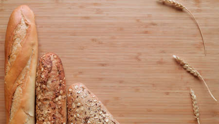 Different types of bread, fresh pastries in the bakery. Bread with sesame seeds, cereals, seeds....
