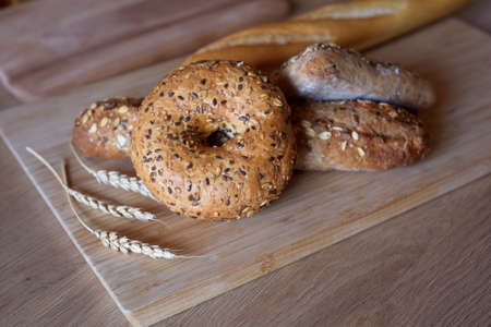 Different types of bread, fresh pastries in the bakery. Bread with sesame seeds, cereals, seeds....