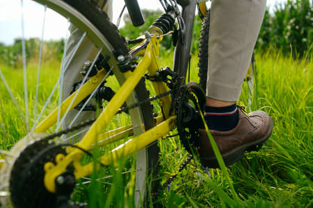 Male feet on pedals, bike, mountain. Wheel
