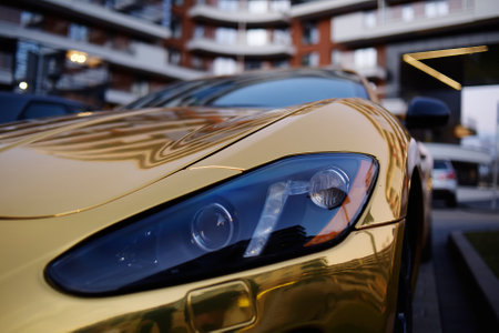 A golden car, a golden car on the street, a luxury car.