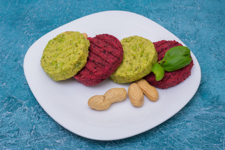 Vegetarian cutlets with chickpeas, patty beetroots, beans basil and peanuts on a plate. Healthy food for vegans, healthy food, menu. Restaurant dish in food delivery.の写真素材