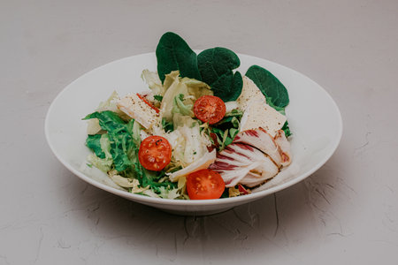 Salad with herbs, cherry tomatoes, camembert spinach and lettuce. Healthy food, breakfast or lunch, dietary dinner and balanced meals.の写真素材