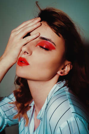Beauty portrait of sexy women with glamor make up. Red lips and red eyeshadows, neils. Beauty...