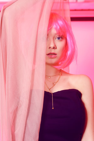 Girl with pink hair, brown hair. Model in a pink long dress, flying dress, fabric. Pink makeup, style, fashion. Anime girlの写真素材