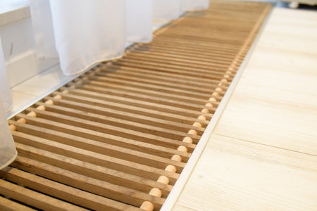A white curtain flies in the wind. Ventilation and floor heating near the balcony. Insulation in the floor.の写真素材