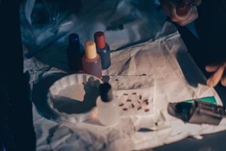 Male hands refill printer cartridge. The guy makes holes in the cartridge and pours ink through the syringe The needle makes a hole in the cartridgeの写真素材