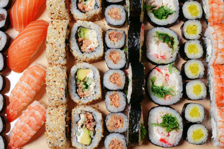 Maki and nigiri, sushi with fish, fresh salmon, shrimp and cheese, avocado rolls. Futomaki and Philadelphia with California. Set of sushiの写真素材