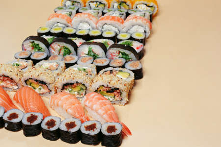 Maki and nigiri, sushi with fish, fresh salmon, shrimp and cheese, avocado rolls. Futomaki and Philadelphia with California. Set of sushiの写真素材
