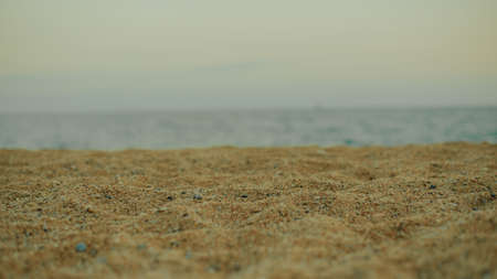 Blurred photo of sand and beach against the backdrop of the sea or ocean, place for your productの写真素材