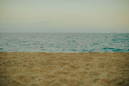 Blurred photo of sand and beach against the backdrop of the sea or ocean, place for your productの写真素材