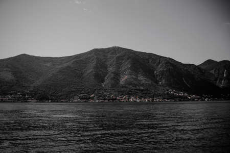 Black and white photo of mountains and bad weather. Vibe cold photo. Mountains near the river, sea,...