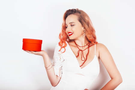 New year christmas girl holding her gift in a red box.の写真素材