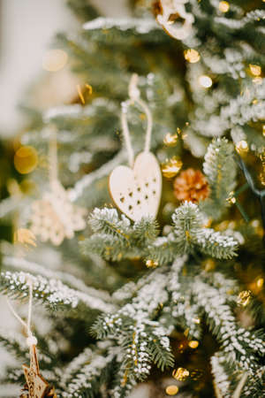 New year 2022, christmas. House room decorated for the holidays. Cones on the tree and wood decorations, eco.の写真素材