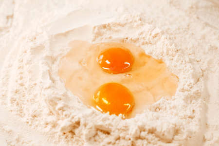 Cooking homemade dough, flour and eggs on the table. Cooking at home, recipes, diet. Pie or cake dough, sweet.の写真素材