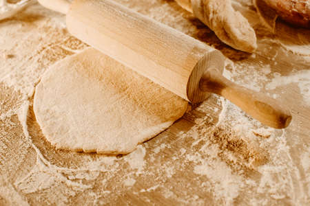Making homemade dough. The stretcher rolls out the dough for pizza, ravioli or bread. home cooking dietの写真素材