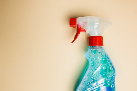 Sprayer for windows lies on a nude background. Cleanliness of windows and kitchen surfaces: cleaning.の写真素材