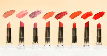 Lipstick different colors, shades options. Cosmetics on nude background. Beautiful examples of lipsticks, pink and red. Fashionの写真素材