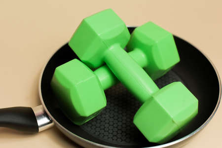 Weights in a pan, what to eat to lose weight, proper nutrition and diet.