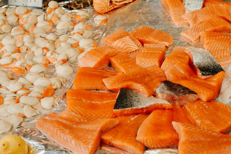 Seafood stall on the street, salmon, shrimp and white fish, a large selection of healthy food in the marketの写真素材