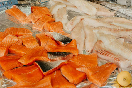 Seafood stall on the street, salmon, shrimp and white fish, a large selection of healthy food in the marketの写真素材