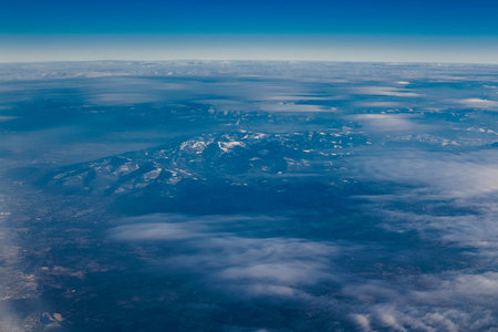View of the city and mountains from above from a drone and an airplane. Cities aerial view, sky and clouds.の写真素材