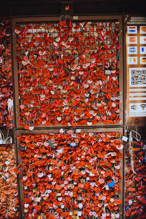 Many red locks in the form of hearts with the names of lovers. Near Juliet's house in Verona. Love, sympathy. hearts lock Italyの写真素材