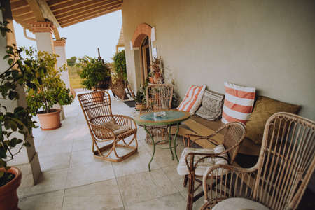 Beautiful Italian-style terrace in a field with olive fields in the background. Comfort and relaxation, boho styleの写真素材
